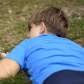 Young boy watching closely a columbian ground squirrel (Urocitellus columbianus)
